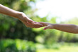 © kowitstockphoto - Mother's and child hold hands. Happy in the garden. Mother's love in the hand, on the palm