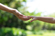 © kowitstockphoto - Mother's and child hold hands. Happy in the garden. Mother's love in the hand, on the palm