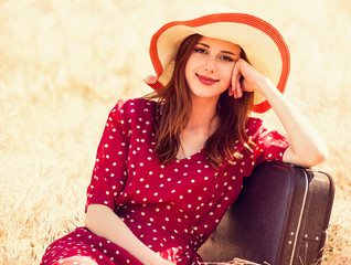 Sticker - Redhead girl with suitcase sitting at grass