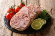 Healthy tasty food head cheese or brawn and fresh tomatoes, lime and cilantro closeup on a slate board. horizontal