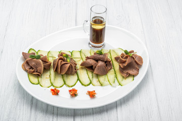 Wall Mural - Boiled beef tongue on dark wooden table with pesto and salad