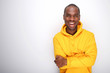 © mimagephotos - happy african american man laughing with hoodie by white wall