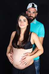 Wall Mural - Young couple expecting baby pregnant standing together indoors