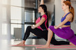 © Denys Kurbatov - Two fit flexible women doing yoga exercise in studio