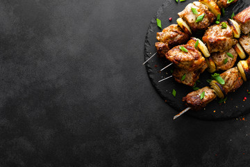 Canvas Print - Grilled meat skewers, shish kebab on black background, top view