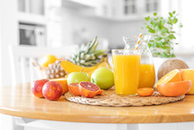 Multifruit Juice And Fresh Fruit On Table On Kitchen Background Closeup