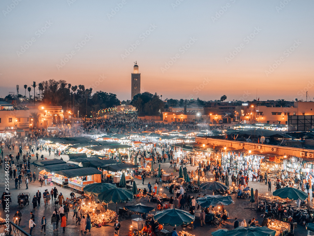 Djemaa el Fna - a famous market place in Marrakech, Morocco while sunset - obrazy, fototapety, plakaty 