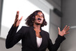 © TheVisualsYouNeed - young attractive and confident black African American business woman with headset speaking in auditorium at corporate training event or seminar giving motivation conference
