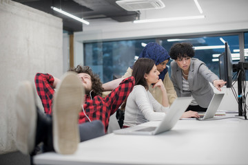 software developer resting with legs on desk