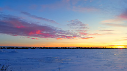 Wall Mural - Beautiful Sunset and Pink clouds over frozen lake