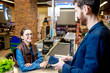 © rh2010 - Businessman with happy woman cashier at the cash register buying food in the supermarket