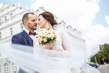 loving couple of newlyweds walks in the old city in wedding day