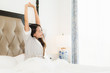 © siraphol - Portrait beautiful young asian woman wake up with happy and smile on bed in bedroom interior