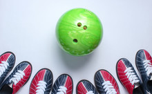 Indoor Family Sports. Many Bowling Shoes And Bowling Ball On White Background. Top View. Minimalism