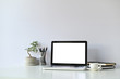 © Prathankarnpap - Mockup laptop computer and office supplies and small bonsai on workspace.