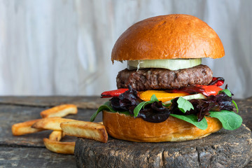 Wall Mural - Venison burger in brioche bun with peppery leaf salad, onion and roast peppers