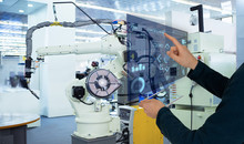 The Engineer Uses A Futuristic Projection Touch Screen To Control Robots In A Smart Factory. Smart Industry 4.0 Concept