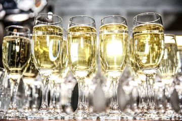 glasses of white sparkling wine sparkle in the light. background of glasses with sparkling wine