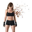 © gearstd - Young fit woman in gym clothes looking down, one arm practically dissolved in particles, isolated on white background.