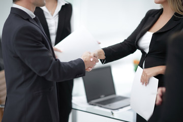 close up.handshake business partners in the background of the office