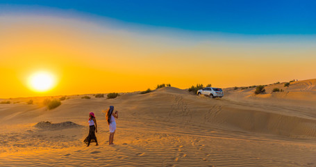 dubai, united arab emirates - december 13, 2018: jeep safari at sunset over sand dunes in dubai dese