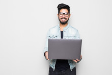 Young Indian Man In Eyesglasses And Casual Wear Holding Laptop White Standing Isolated On White Background