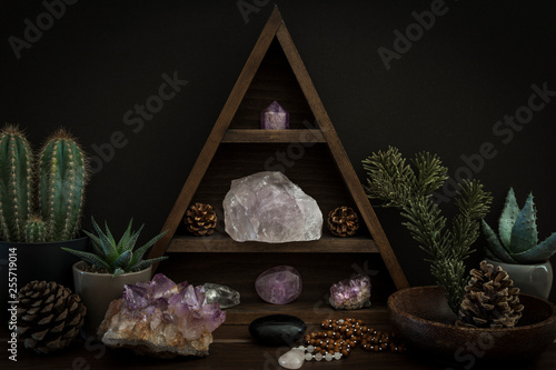Fotografía Triangular Crystal Shelf with Plants Foliage Gems and Jewellery on a Wooden Surf