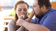 Obese loving couple sharing ice-cream, sugary sweet dessert, flirting on date