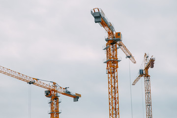 Construction of modern high-rise buildings. Cranes and machinery