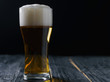 Glass of lager on a dark background