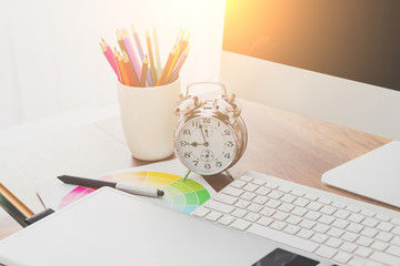 Wall Mural - Young Handsome Graphic designer using graphics tablet to do his work at desk