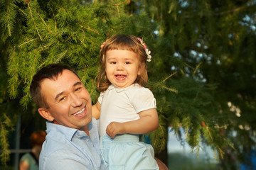 Wall Mural - playing father and daughter. child and dad in the summer