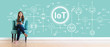 © Tierney - IoT theme with young woman holding a tablet computer