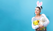 Young Woman With An Easter Bunny On A Blue Background