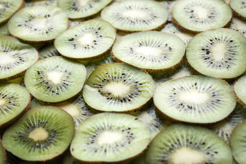 Canvas Print - Kiwi slices background. Slices of ripe kiwi. Kiwi background