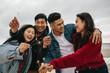 © Jacob Lund - Group of asian friends celebrating new year's day ay beach