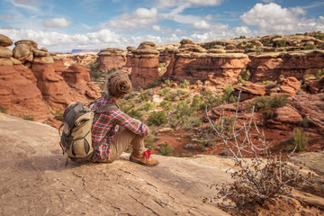 Poster - Hiker in Canyonlands National park, needles in the sky, in Utah, USA