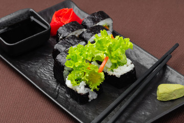 sushi on a black plate