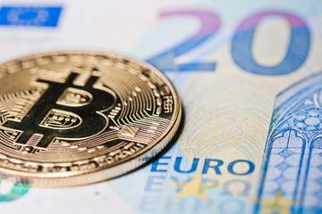 Bitcoin, close-up. Cryptocurrency. Euro banknotes background