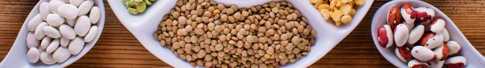 Wall Mural - Various assortment of legumes - beans, soy beans, chickpeas, lentils, green peas. Top view banner format