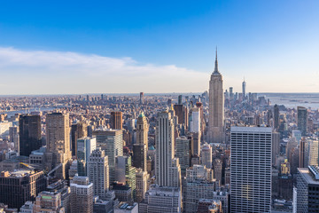 New York City Skyline in Manhattan downtown with Empire State Building and skyscrapers on sunny day with clear blue sky USA