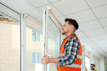 Sticker - Construction worker installing plastic window in house