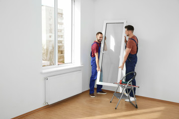 Sticker - Construction workers installing plastic window in house