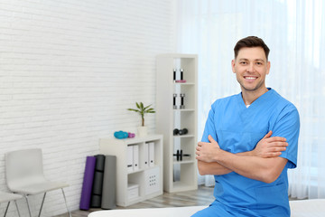 Canvas Print - Professional physiotherapist waiting for patients in rehabilitation clinic. Space for text