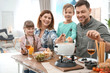 © New Africa - Happy family enjoying fondue dinner at home