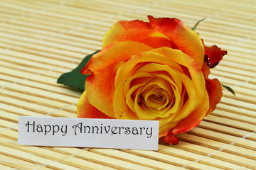 Wall Mural - Happy anniversary card with one colorful rose on bamboo mat