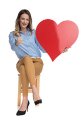 Canvas Print - young smart casual woman holds big valentine's day heart