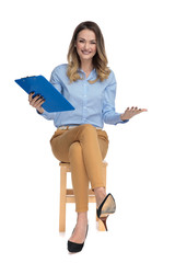 Poster - curious seated smart casual woman holds clipboard in the air