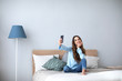 © BestForYou - Beautiful happy woman at home on the couch do selfie on cell phone.