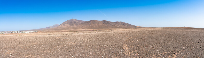 Wall Mural - Panoramic view desert region  Playa Blanca Papagayo - White Beach Papagayo, - at volcanic island Lanzarote, Canary Islands, Spain.  Travel vacation concept.